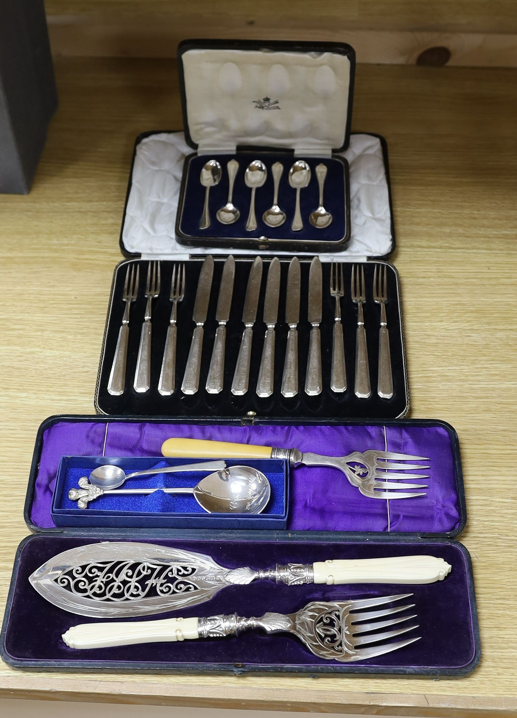 A cased pair of servers, and serving fork, cased silver coffee spoons, royal commemorative spoon, trefid coffee spoon, plated set of dessert knives and forks